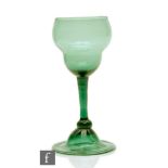 An 18th Century Bristol green drinking glass circa 1755, the swollen ogee form bowl above a