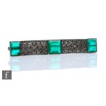 An Art Deco French silver rectangular brooch set with three green paste stones to white paste