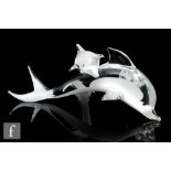 A later 20th Century glass sculpture formed as a stylised dolphin with a smaller dolphin resting