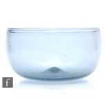 An 18th Century large glass bowl, of high sided circular form, all in a smoky grey ground,