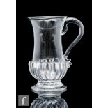 An 18th Century glass tankard, circa 1750-1760, with gadrooned base and applied reeded handle,