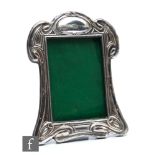 A George V hallmarked silver photograph frame in the Art Nouveau style with sinuous linear