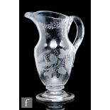 An 18th Century etched lead glass ale jug, circa 1780, of footed baluster form, engraved with the