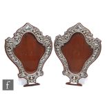 A pair of Victorian hallmarked silver photograph frames, the cartouche shape with a border of