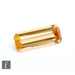 A loose cut and polished rectangular cut natural yellow topaz stone, length 15mm, width 5.8mm, depth