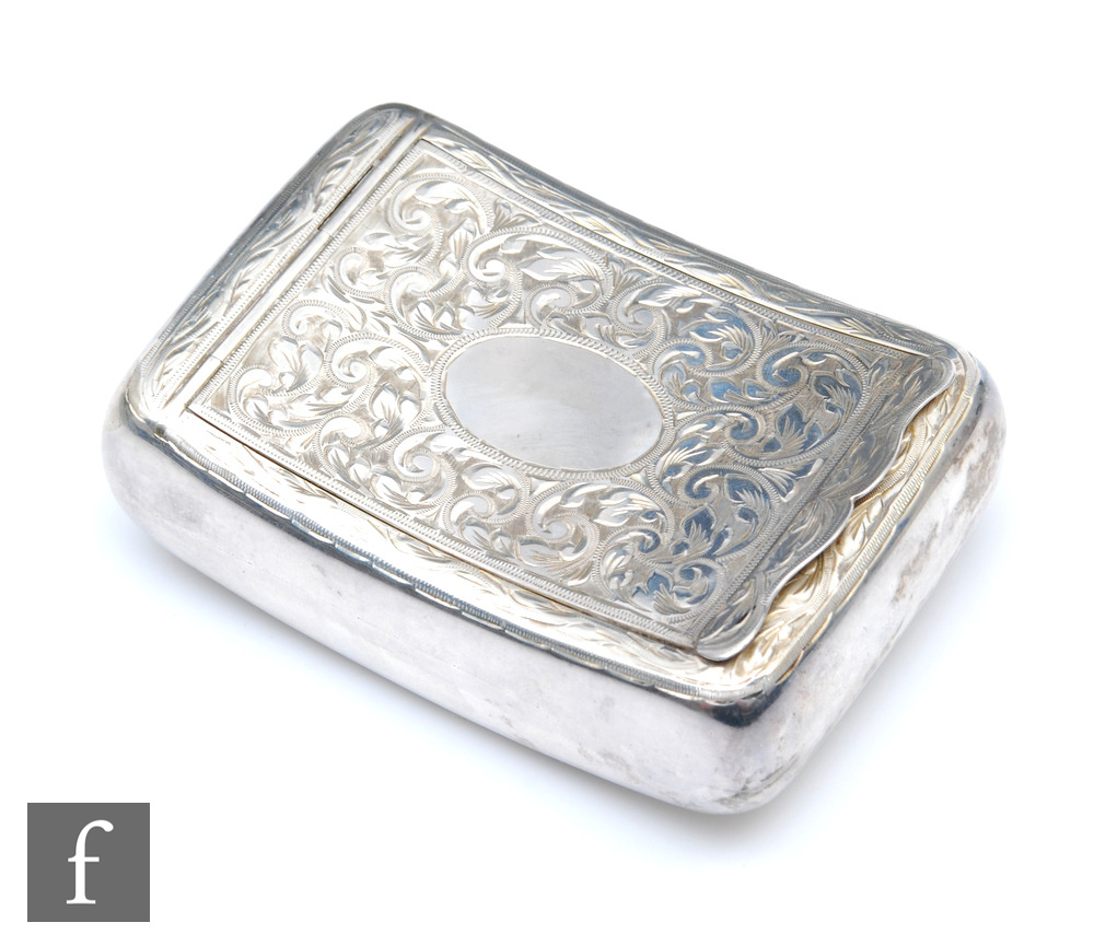 A hallmarked silver cushioned rectangular tobacco box with engraved foliate decoration to hinged lid