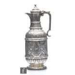 A Victorian hallmarked silver water jug with aesthetic style foliate scroll decoration to whole