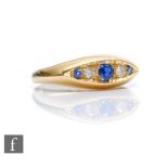 An 18ct hallmarked sapphire and diamond boat shaped five stone ring, alternating stones to plain