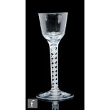 An 18th Century drinking glass circa 1765, the ogee bowl above a double series opaque twist stem