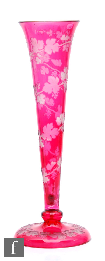 A large late 19th Century Stourbridge glass ruby lily vase, the tall flared trumpet raised to a ball