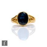 A 22ct hallmarked silver stone sapphire ring, collar set oval stone, length 11mm, to split