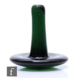 A 19th Century green glass linen smoother, circa 1800, with plain handle above a domed base,