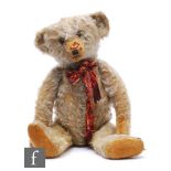 An early 20th Century German Steiff teddy bear, circa 1908, blonde mohair, boot button eyes,