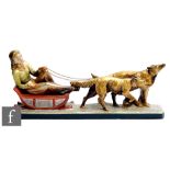 An Art Deco painted plaster study depicting a female figure reclining on a sledge pulled by two