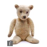 A 1940s Chiltern teddy bear, blonde mohair, vertically stitched nose, rexine paw pads, height