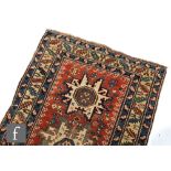 A Shirvan flat woven rug of deep blue, rust and oatmeal ground colours, with triple medallions to