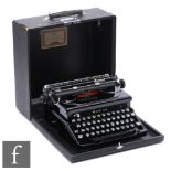 A 1940/50s Italian Everest portable typewriter, in black leatherette case with some fragmented