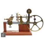 A watch maker's 6mm Lorche lathe with five spoke wheel, on later stepped mahogany plinth base, width