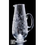A 20th Century clear crystal glass jug, of tapering ovoid footed form with applied loop handle,