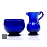 An early 19th Century Bristol blue glass jug, circa 1800, of squat ovoid footed form and flared neck