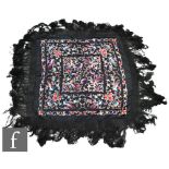 A 1920s Chinoiserie embroidered Manila (or piano) shawl, the black silk ground with red, pink,