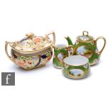 An early 20th Century Noritake teapot, milk jug and sugar bowl each decorated with hand painted