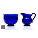 An early 19th Century Bristol blue glass jug, circa 1800, of squat ovoid form and flared neck with