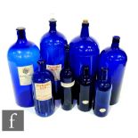 Four large cobalt blue chemists bottles labelled carbolic acid, poison, lead acid, tallest 40cm