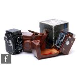 A Yashica 44 camera with original box and instructions, a Rolleicord camera, no case, and a Reflex-
