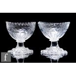 A pair of late 18th Century clear crystal Irish salts of ovoid form, decorated with cut husk boarder