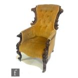 A Victorian easy chair with carved exposed mahogany frame, with scroll capitals and cabriole front