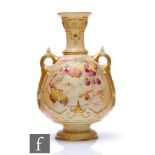 A Royal Worcester shape 1553 blush ivory twin handled vase decorated with gilt and enamel autumnal