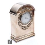 An Edwardian plated mantle clock in the Art Nouveau style, the domed top over a white enamelled dial
