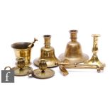 An Indian brass bell form dwarf candlestick, a similar plain example, a pair of small chamber