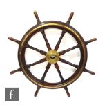 A large 19th Century mahogany and brass ships wheel with central fixed boss and eight radiating