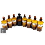 A set of seven early 20th Century amber chemist jars, each with a stopper, named SP.VINI.RECT, OL.