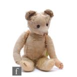 A 1930s Merrythought teddy bear, faded pink mohair, amber and black glass eyes, fully jointed,