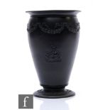 A 19th Century Wedgwood Neo Classical black basalt vase decorated in low relief with a maiden and