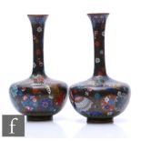 A pair of late Meiji period Japanese cloisonne vases, each of bottle form, decorated with roundels