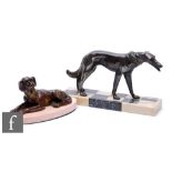 A 20th Century bronze study, modelled as a recumbent spaniel, mounted to an oval marble base, height