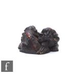 A Japanese carved hardwood carving or netsuke, modelled as two carved shishi entwined, height 3cm.