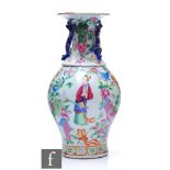 A Chinese late Qing Dynasty famille rose vase of baluster form, rising to a flared neck flanked by