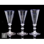 A near set of three 18th Century ale glasses circa 1780, each with a blue rimmed conical bowl