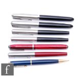 Four Parker black cased fountain pens, a red cased example, another and a propelling pencil. (7)