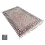 An Agra style Persian rug, the central medallion bordered by floral entwinned scrolls within multi