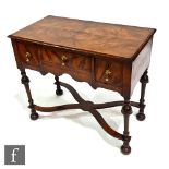 An 18th Century and later constructed feather banded walnut lowboy, the quartered top over a