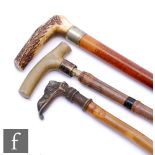 A Victorian bamboo and horn handle walking stick, concealing a key to open a carriage door,