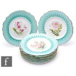 Nine early 20th Century dessert plates, each with a transfer decorated and hand tinted botanical