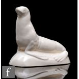 An Art Deco white crackle glaze St Clement figure of a stylised seal, circa 1930s, signed, height