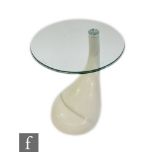 A mid 20th Century style side table, with circular glass top over a white lacquered tapering base,
